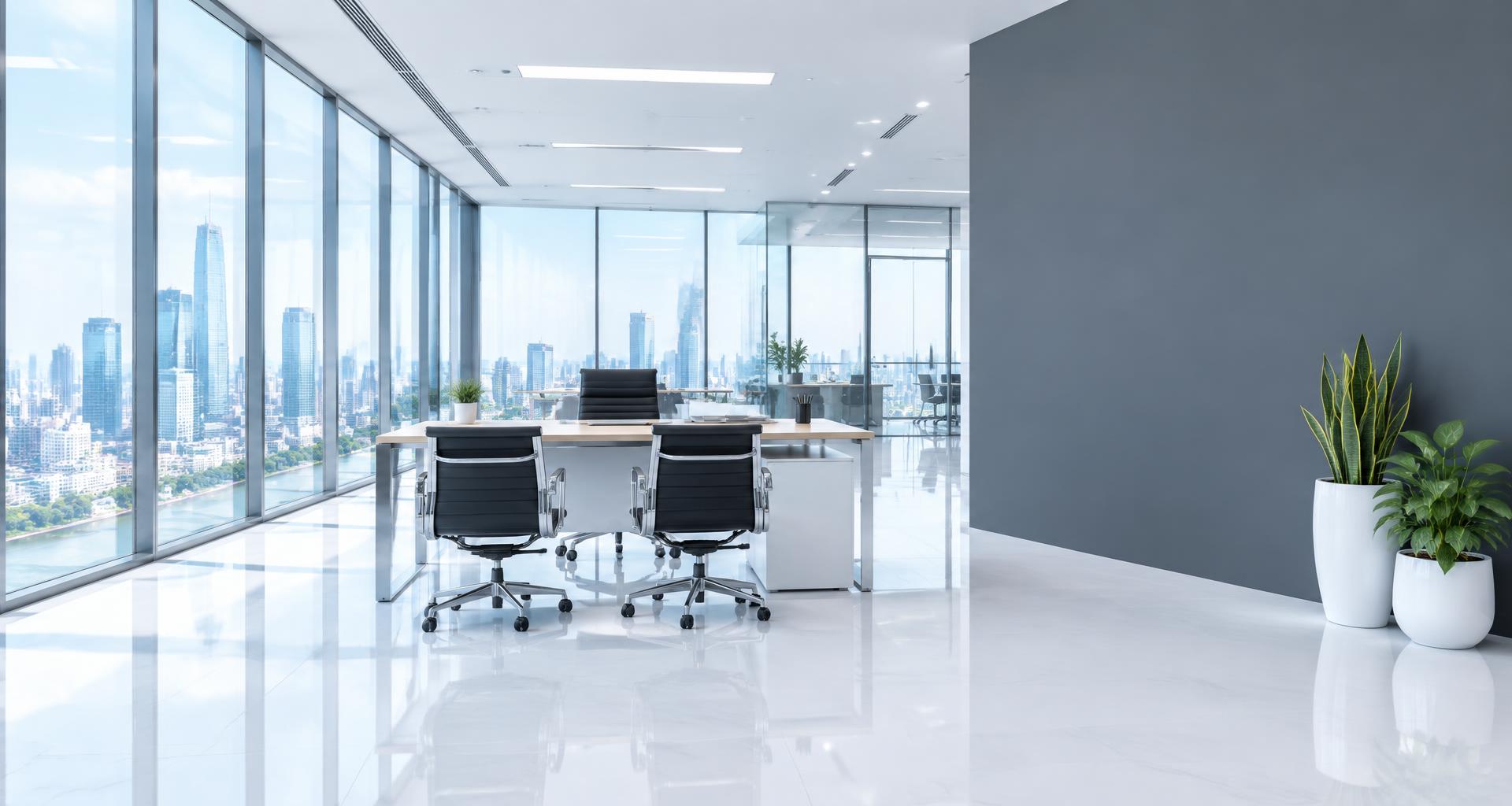 Modern office with glass windows and a grey feature wall